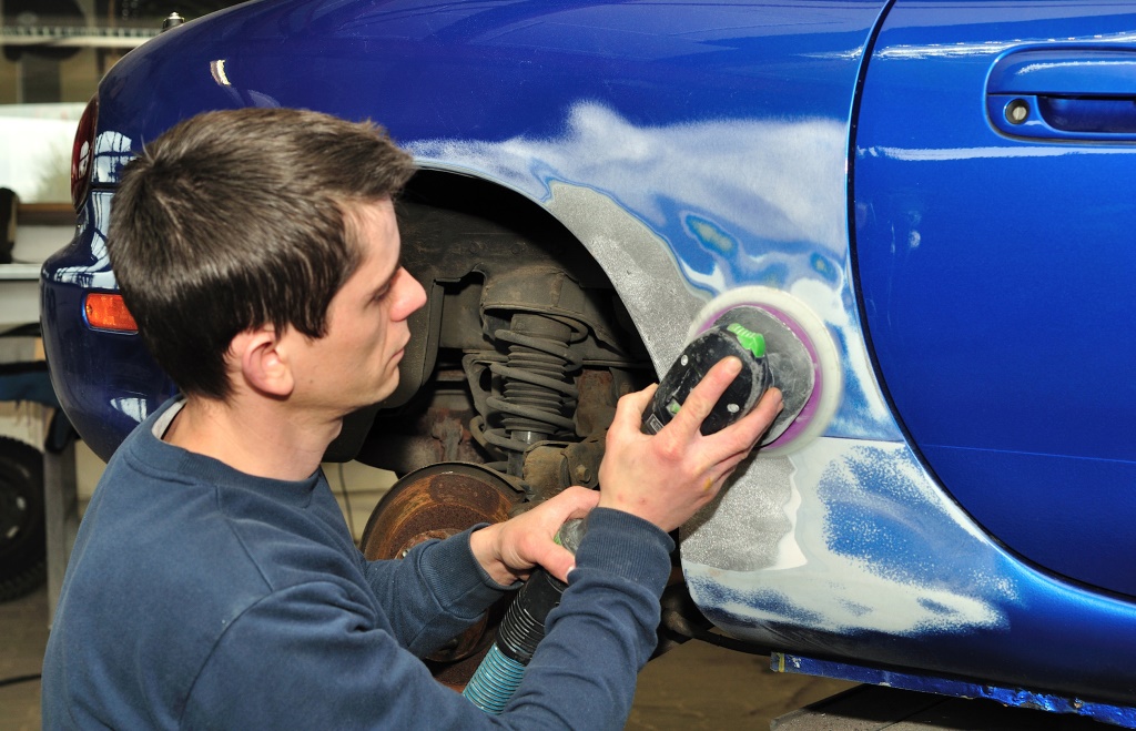 man fixing car